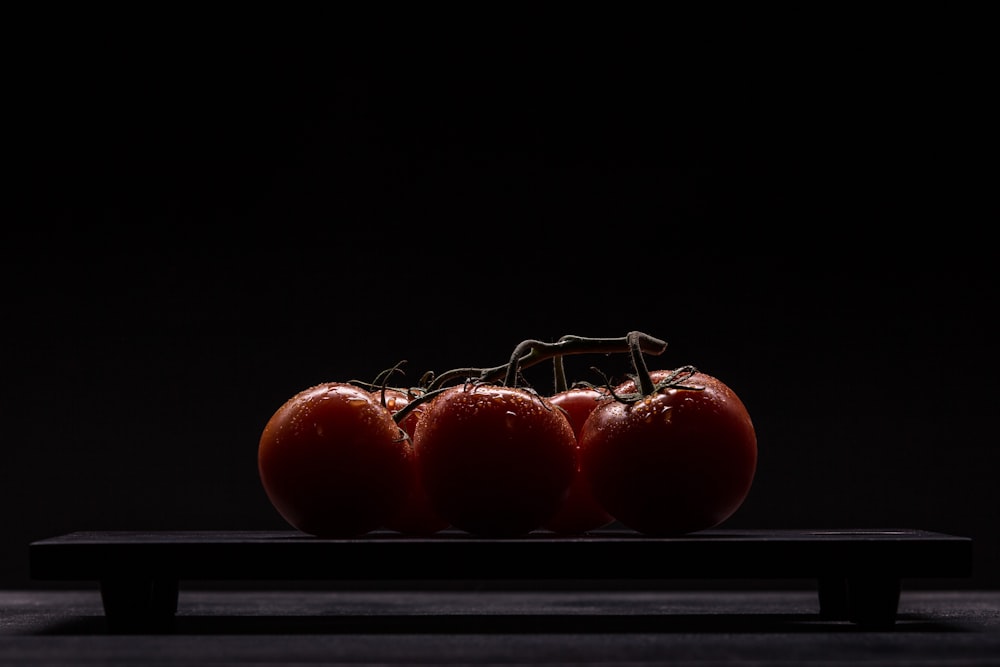 red tomatoes on black surface