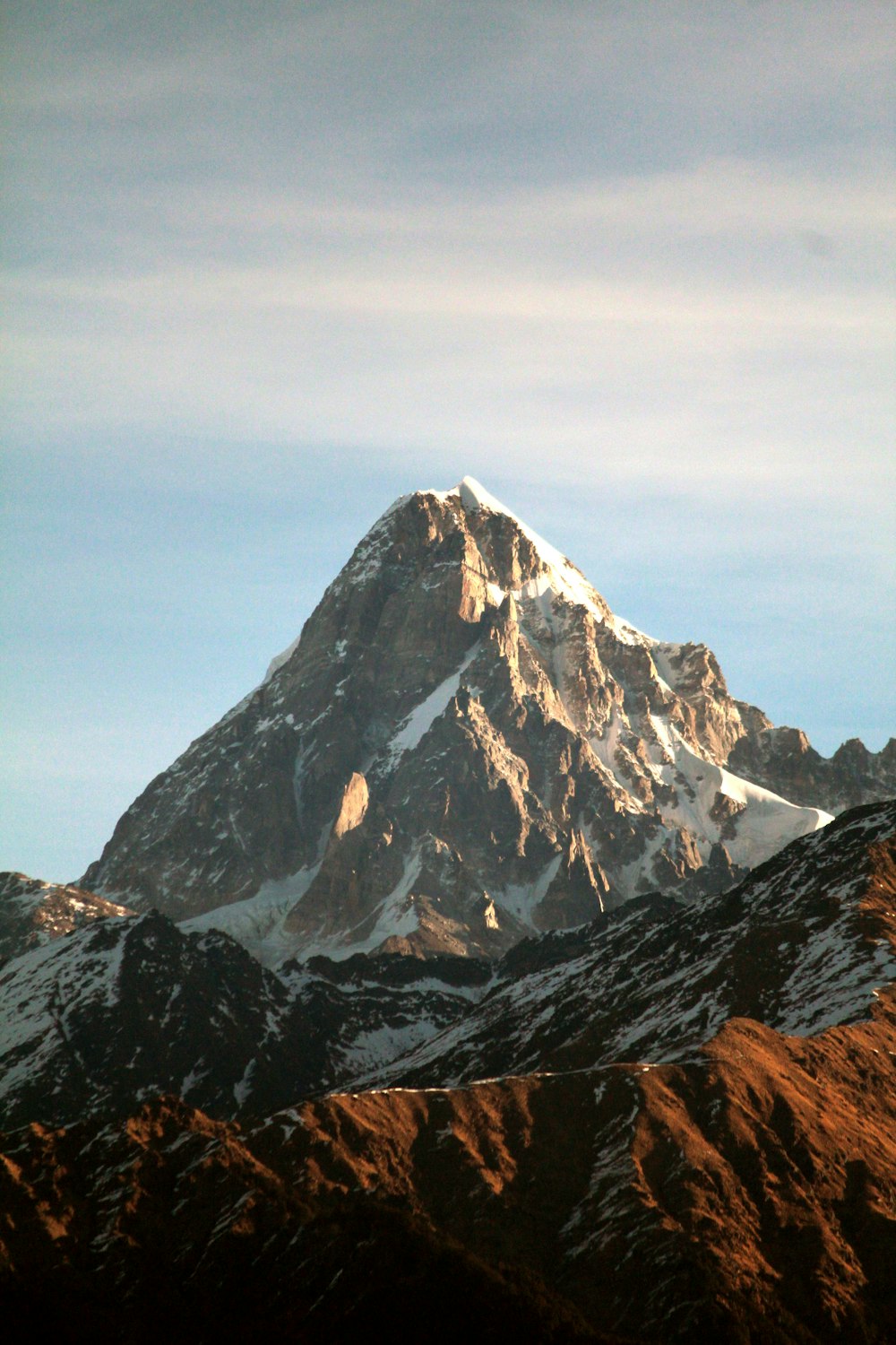 snow-capped mountain ranges under cloudy skies