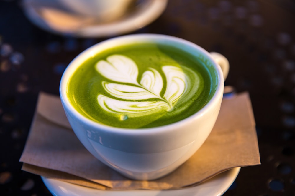 white ceramic teacup filled of matcha tea