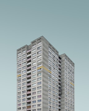 Elegant residential tower with rooftop terrace and city skyline views.