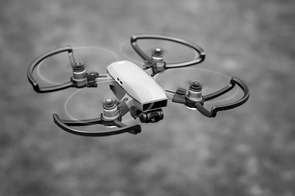 drone flying in gray scale photography