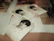An inspiring image of a man looking thoughtfully at old family photos spread on a wooden table.