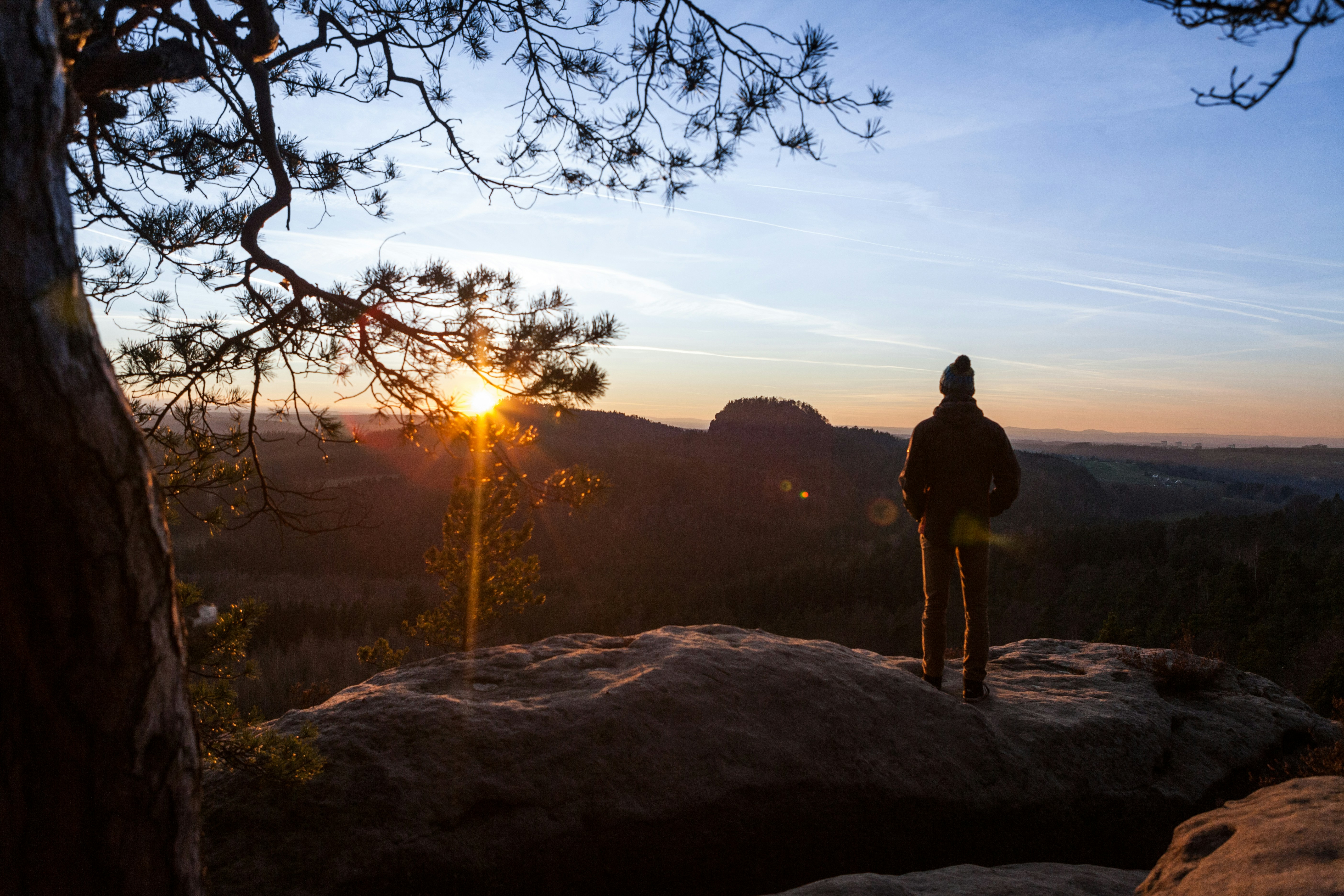 a person standing on top of a large rock