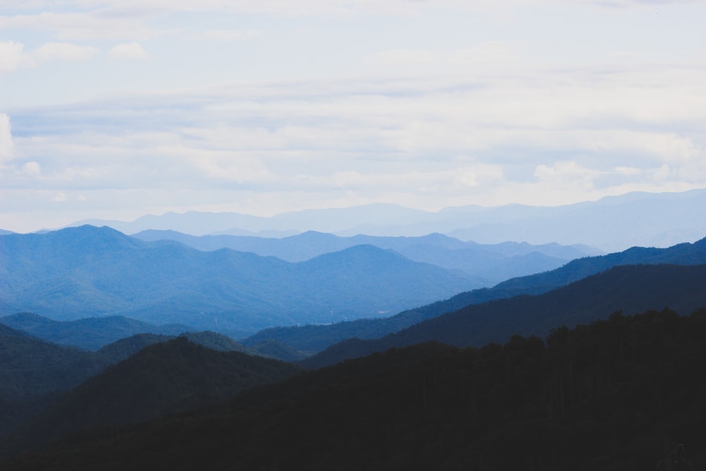 photo of mountains under blue sky