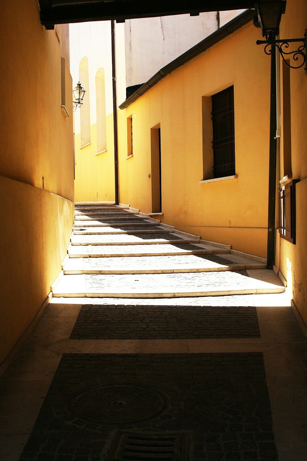 gray concrete alley stairs illuminated