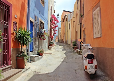 white motor scooter near building italy teams background