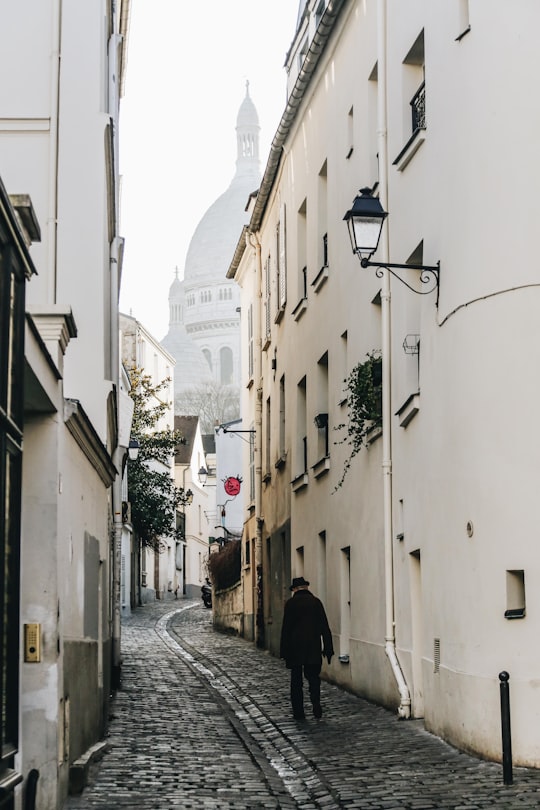 man walking near concrete building in Montmartre France