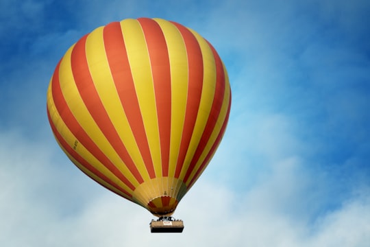 low angle photography of yellow and red stripe hot air balloon in Beaudesert Australia