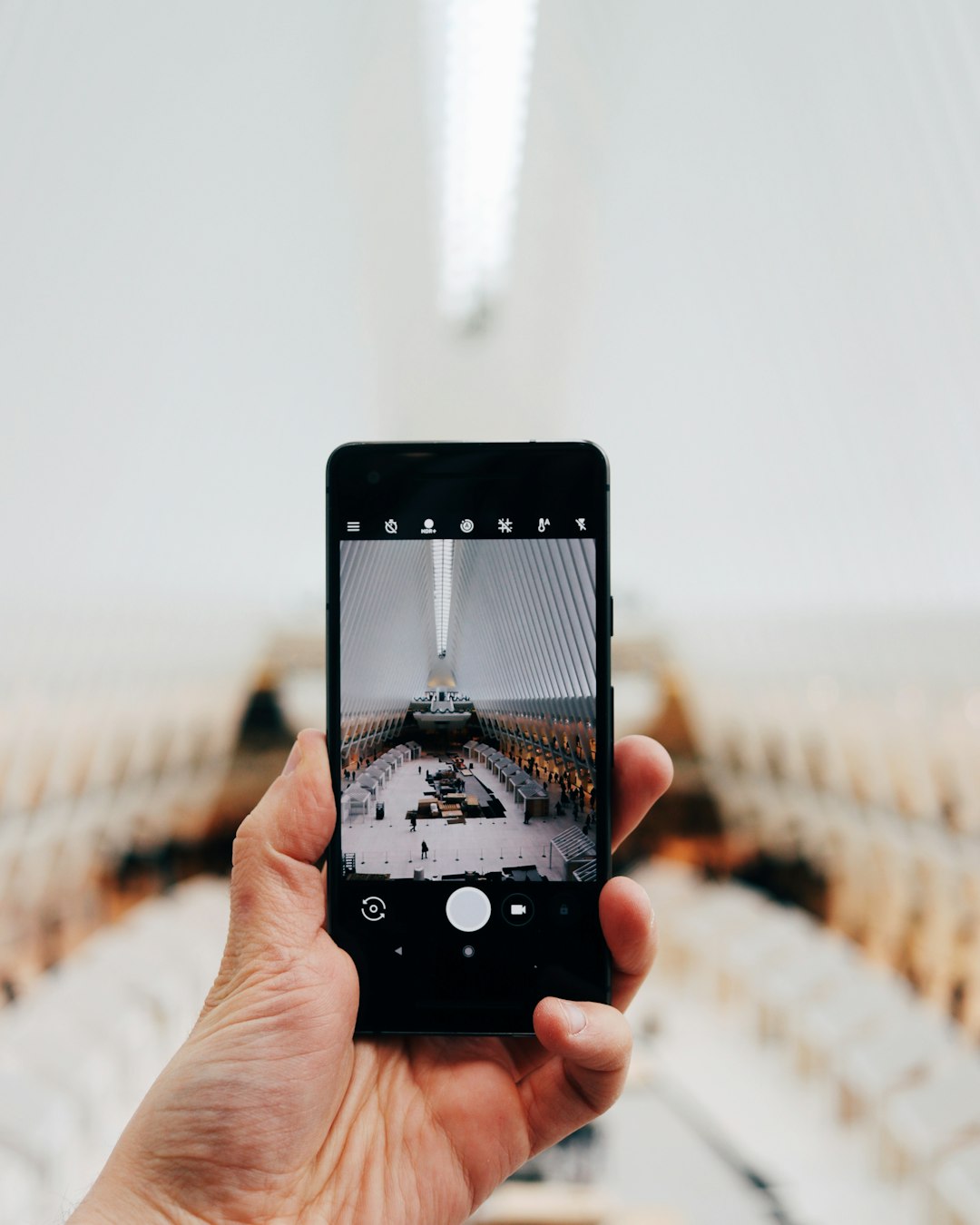 person holding black smartphone taking photo of room