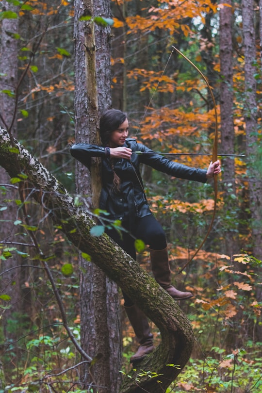 woman in black jacket holding longbow in Uxbridge Canada