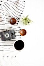black and gray camera beside on brown wooden bowls