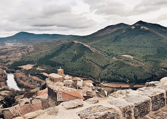 aerial photography of brown buildings and green mountain during daytime in Navarre Spain