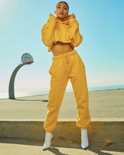 woman in yellow tracksuit standing on basketball court side