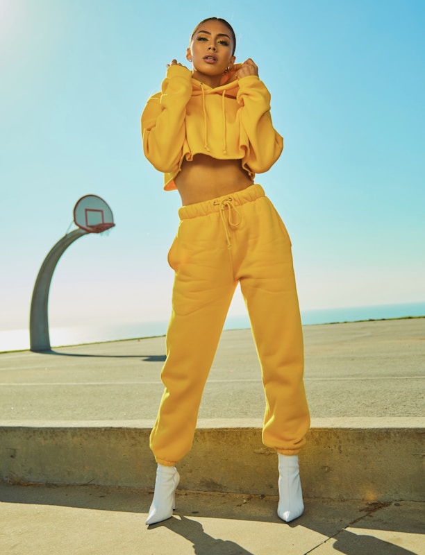 woman in yellow tracksuit standing on basketball court side