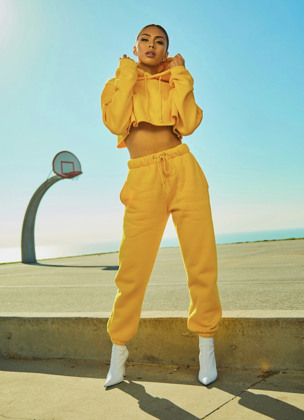 woman in yellow tracksuit standing on basketball court side