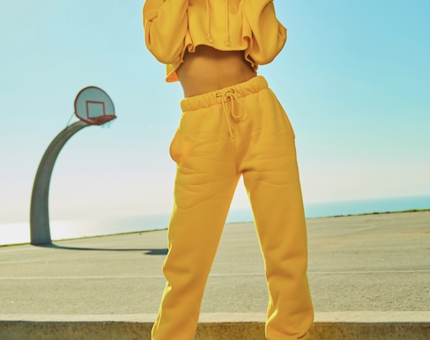 woman in yellow tracksuit standing on basketball court side