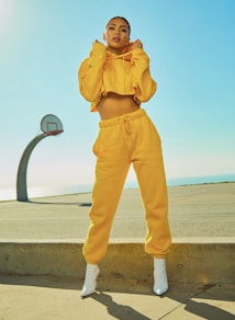 woman in yellow tracksuit standing on basketball court side