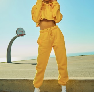 woman in yellow tracksuit standing on basketball court side