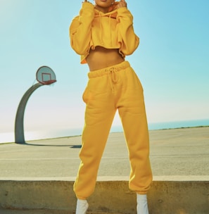 woman in yellow tracksuit standing on basketball court side