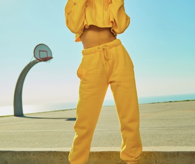 woman in yellow tracksuit standing on basketball court side