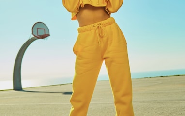 woman in yellow tracksuit standing on basketball court side