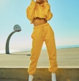 woman in yellow tracksuit standing on basketball court side