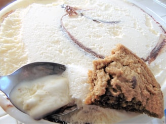 Close-up of creamy vanilla ice cream swirled with rich chocolate fudge in a colorful bowl.