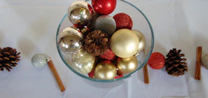 Festive table setting featuring a luxury decorative bowl filled with colorful ornaments