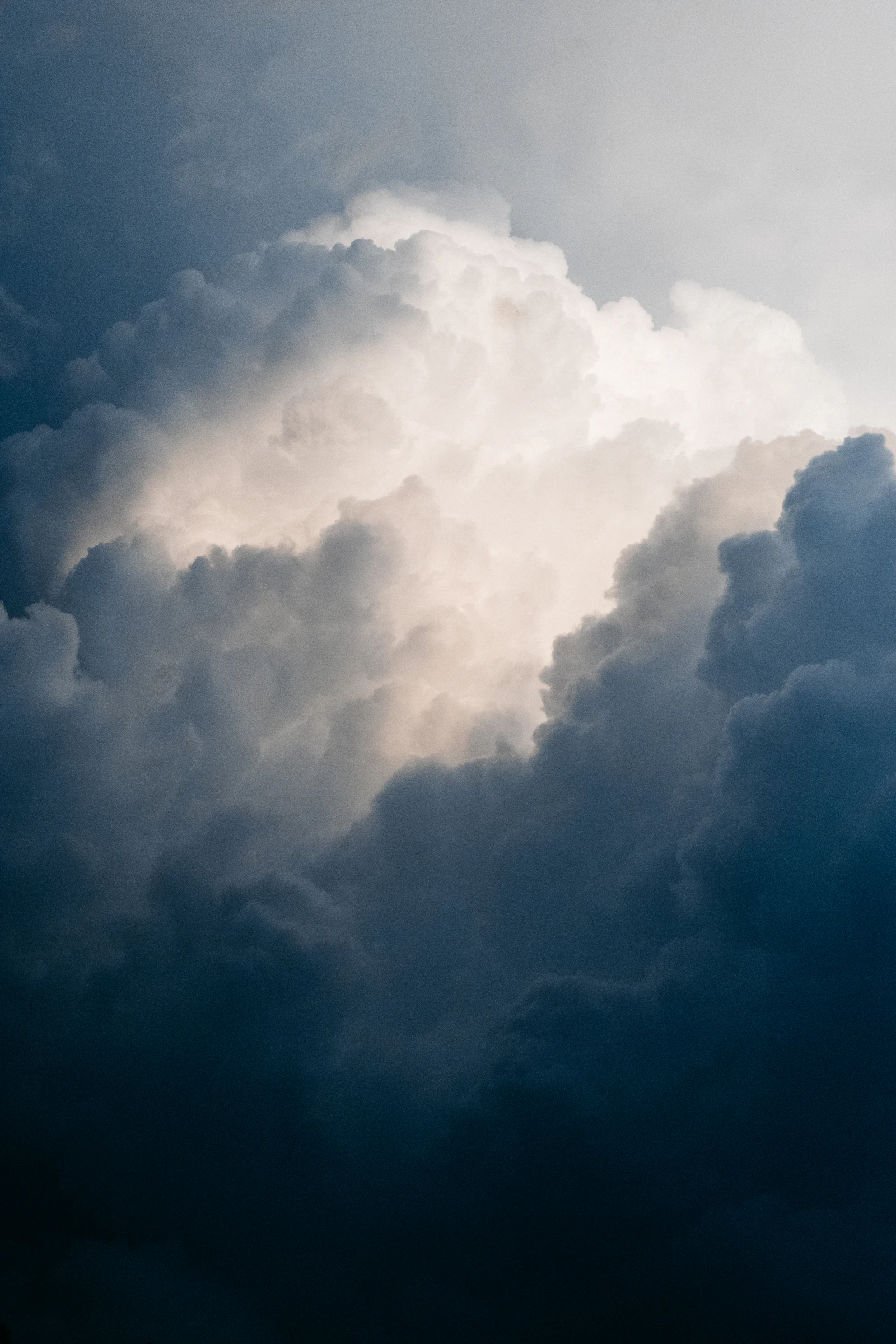 Bright light behind dark storm clouds