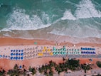 aerial view of brown sand near body of water during daytime