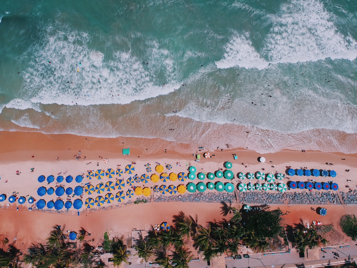 Aerial View Of Brown Sand Near Body Of Water During Daytime