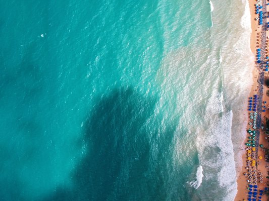 Turquoise surf along the shore from above — Natal, Brazil