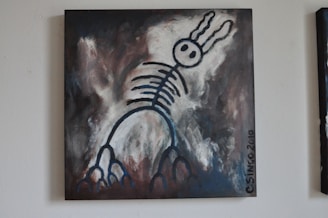 A surreal painting featuring a skeletal figure with rabbit-like ears against a dark, abstract background. The figure is outlined in bold, black strokes with circular eyes and rib-like structures extending down its body. The background blends shades of gray, dark brown, and white, giving the piece a mysterious and moody atmosphere.