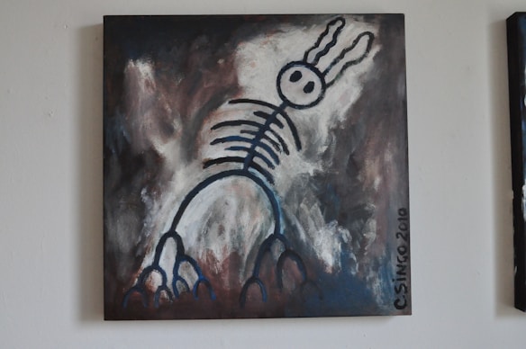 A surreal painting featuring a skeletal figure with rabbit-like ears against a dark, abstract background. The figure is outlined in bold, black strokes with circular eyes and rib-like structures extending down its body. The background blends shades of gray, dark brown, and white, giving the piece a mysterious and moody atmosphere.