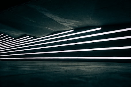 Dark abstract architectural lines converging in a minimalist boardroom setting.