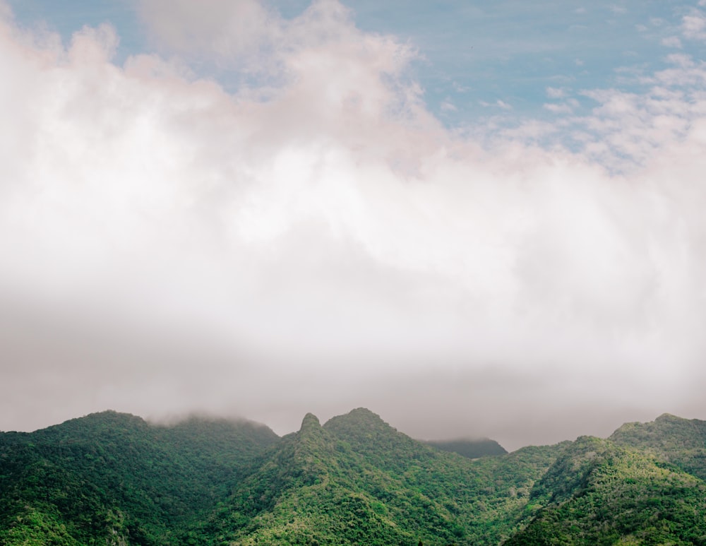 green mountains under white clouds during daytime