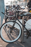 A row of bicycles parked securely in a modern bike rack.