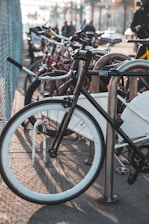 A row of bicycles parked securely in a modern bike rack.