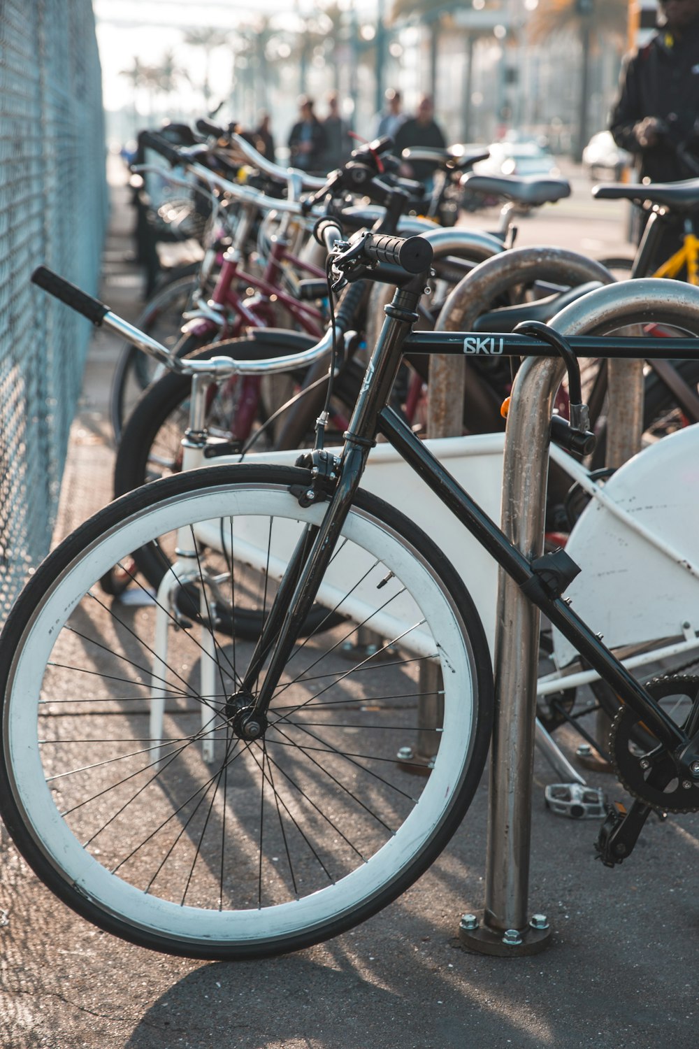 bicycles parked near grey metal fence