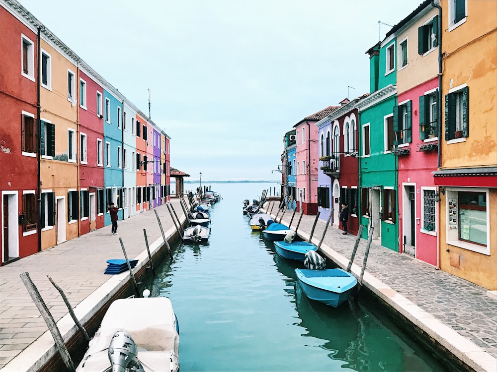 boats parked on the side of the river during daytime