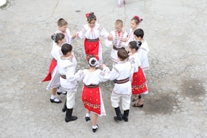Children dressed in traditional western attire participating in a folk dance.