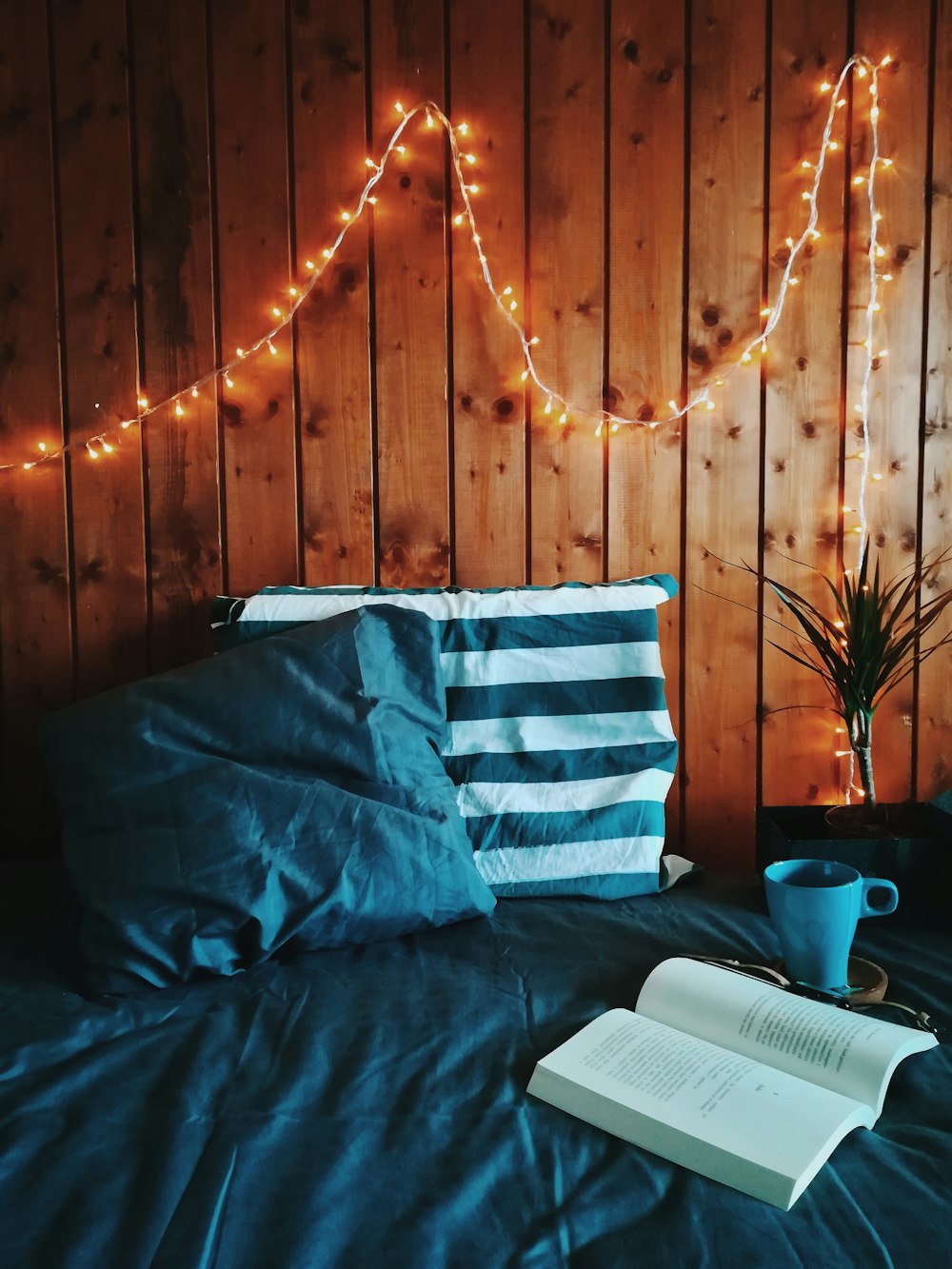 open book beside of blue mug