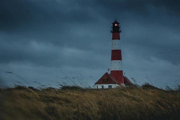 Lighthouse at night with beam of light