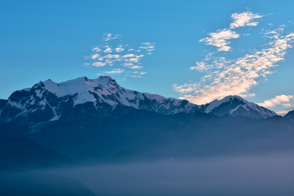 snow covered mountain under blue sky