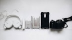 white Sony headphones and black smartphone case