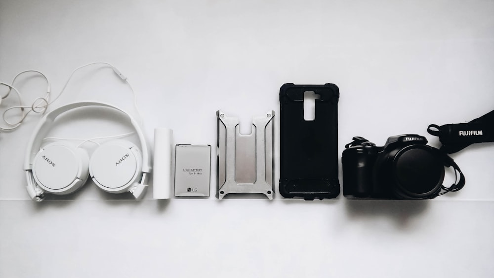 white Sony headphones and black smartphone case