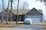Finished front driveway with smooth concrete paving and neat edges beside a suburban home.