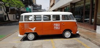 Delivery vehicle branded with ti samoussa 974 logo parked outside a local store.
