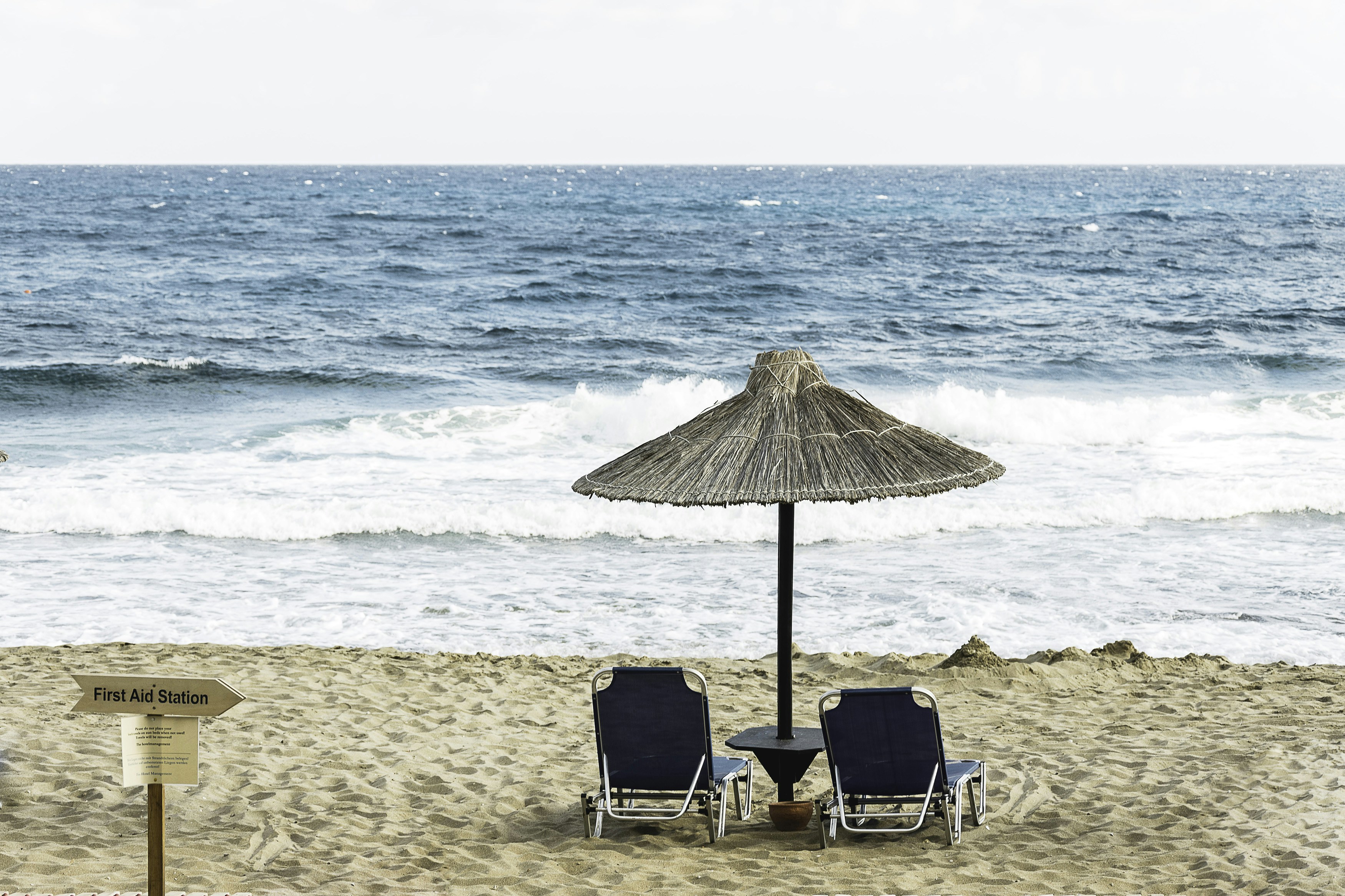 two black beach chair on the seashore