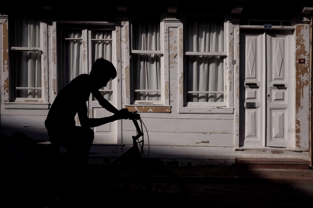 silhoutte of man riding bike